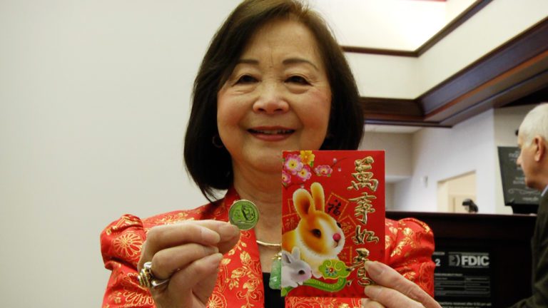 CAWA President Nancy Chen holding the Anna May Wong quarter.