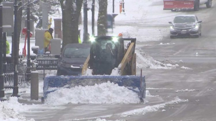 Snowplow moving snow off of street in Naperville
