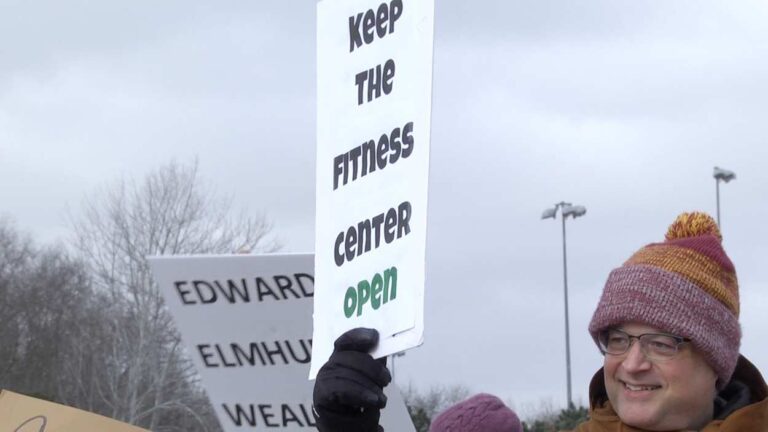 Members protest Naperville Edward-Elmhurst Fitness Center closure. Picture shows Steve Shamrock holding a sign.