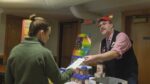 Man hands out brochure at Naper Pride Health and Resource Fair