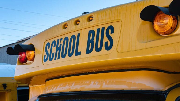 Close up of top front of school bus, with words school bus