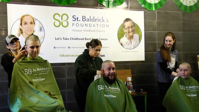 Three participants getting their heads shaved