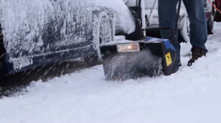 Snowblower blows snow during winter weather
