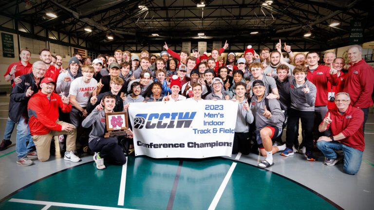 North Central men's indoor track and field team poses with CCIW championship banner