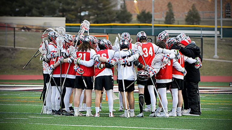 North Central men's lacrosse players huddle before game