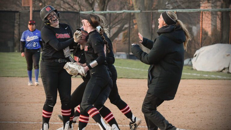 North Central softball players celebrate Torosian walk-off hit