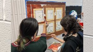 students painting mural