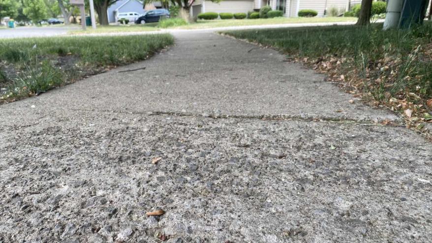 Low angle photo of sidewalk in need of work