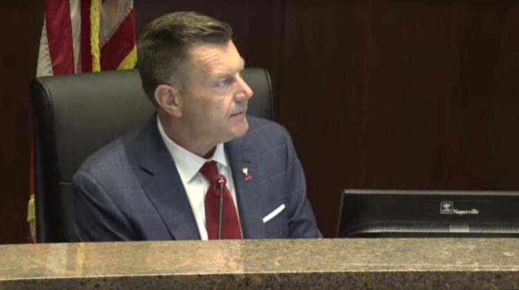 Close up of Naperville mayor Scott Wehrli on council dais discussing Bears pitch