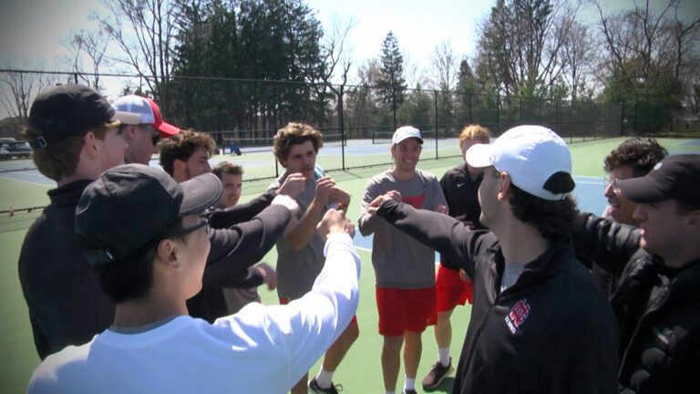 North Central men's tennis players huddle before a match