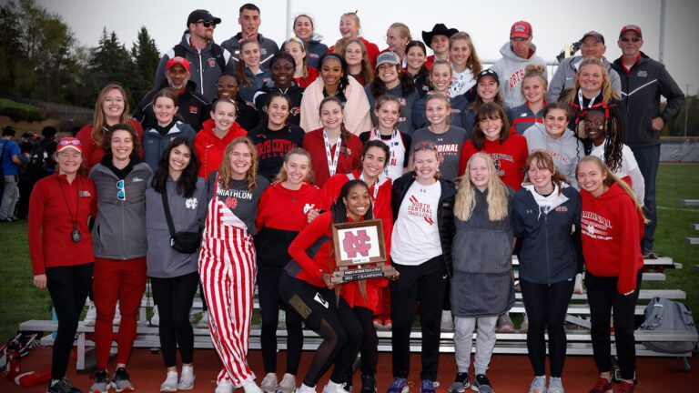 North Central Women's Track and Field pose with their CCIW Championship plaque