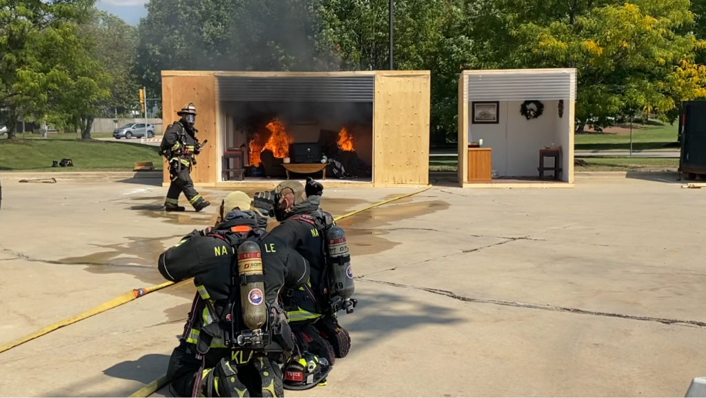 Naperville firefighters demonstrating how they put out fires.