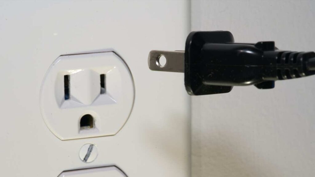 Plug going into electrical outlet