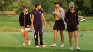 Metea Valley and Naperville North girls golf teammates walk off the green