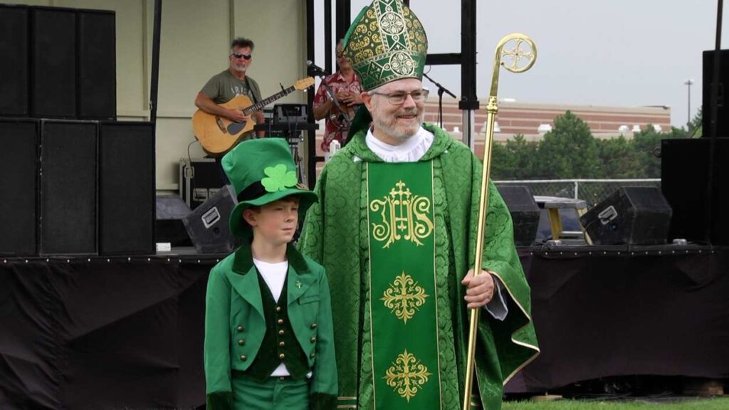 A man dressed as St. Patrick and a boy dressed as a Leprechaun.