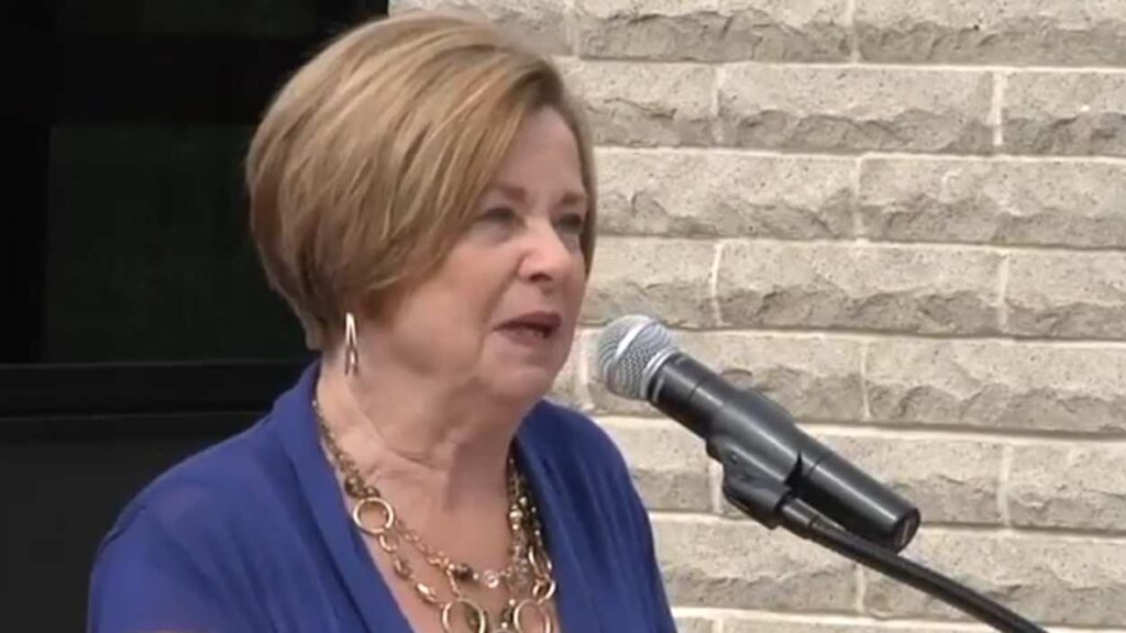 Pat Nicarico at podium in front of microphone