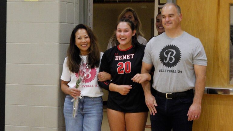 Benet's Charlotte Torres walking out with her family on senior night.