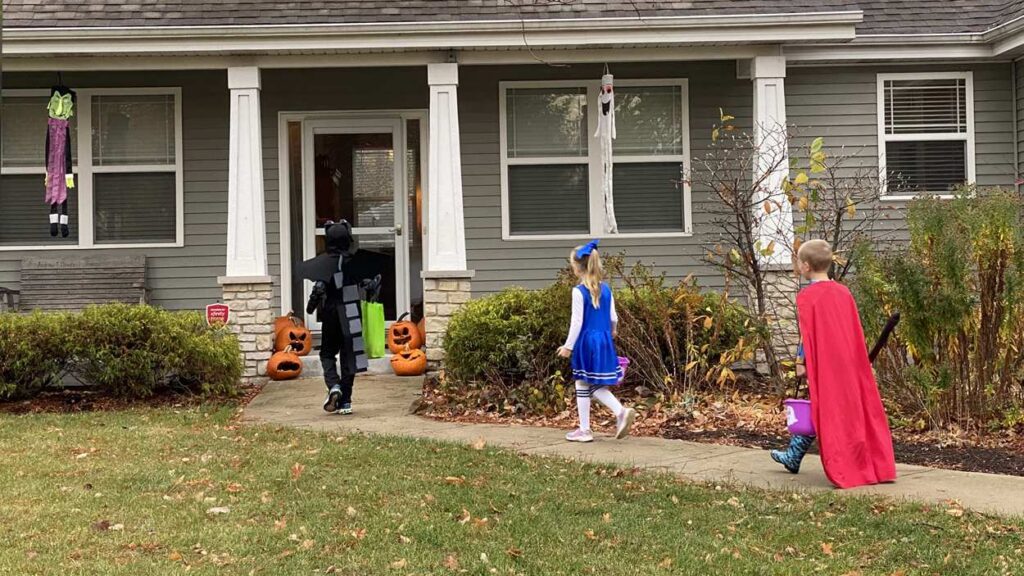 Kids trick-or-treating at house