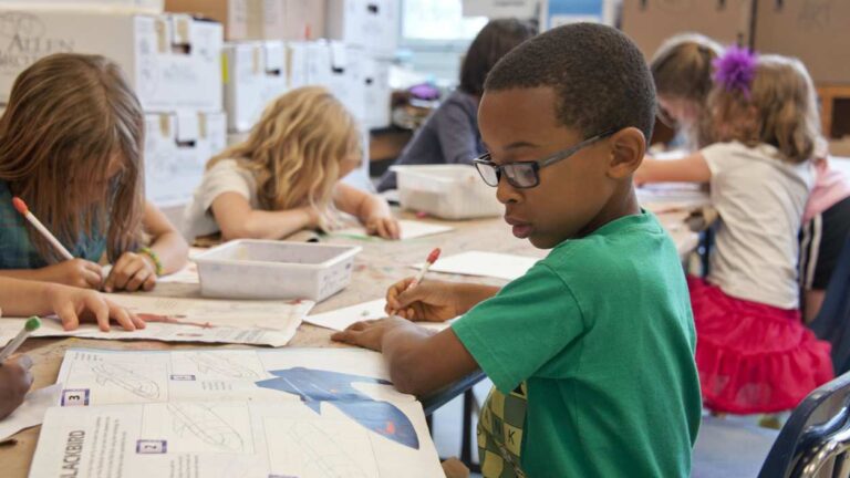 Students sitting at desk at school doing work
