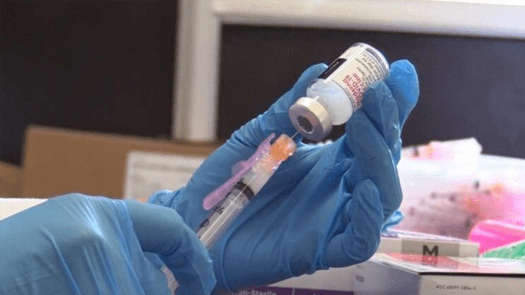 A needle going into a bottle