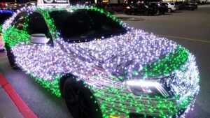 Close-up of front of car featuring white and green lights all over it