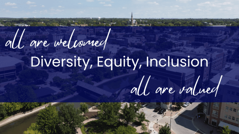 All are welcome, all are valued. Diversity, Equity, Inclusion written across Downtown Naperville aerial picture