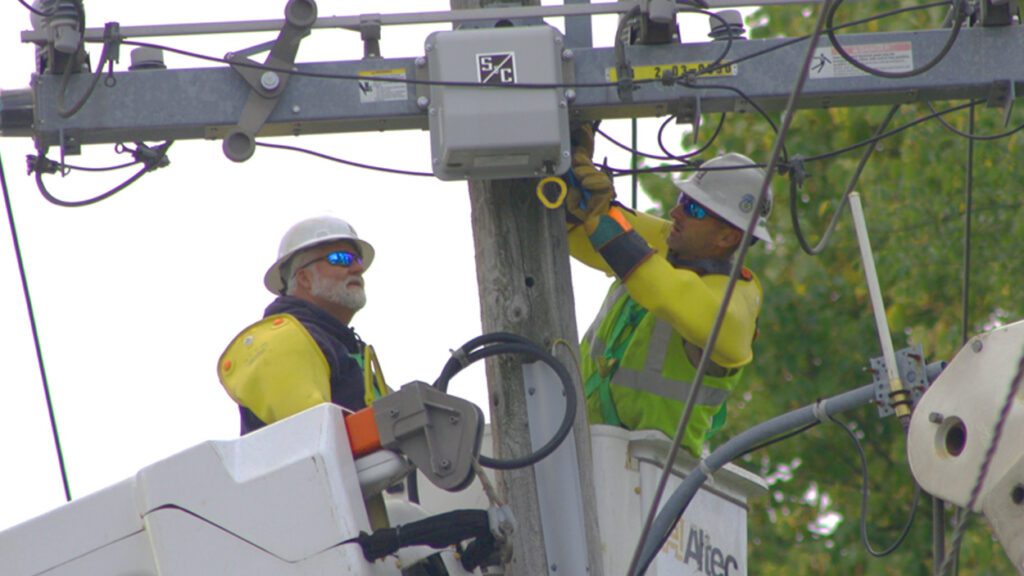 Two linemen from Naperville Electric Utility service electric lines in Naperville