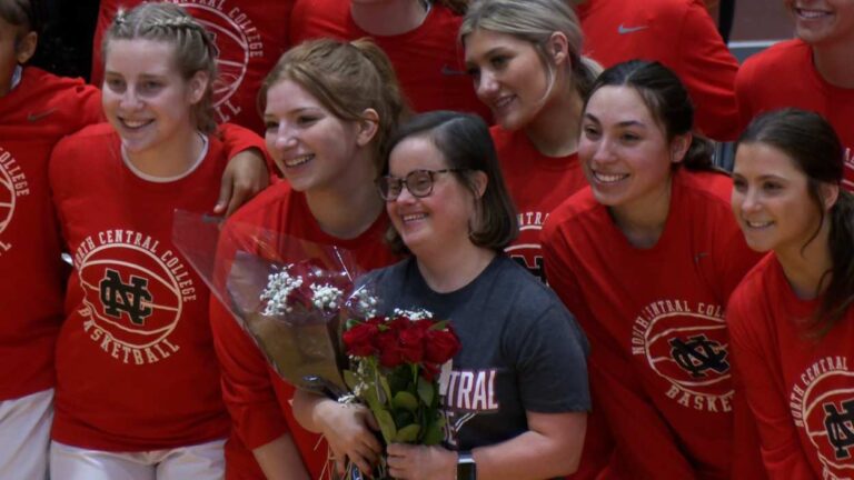 Megan Niklas surrounded by the North Central women's basketball team on her 20 year anniversary celebration