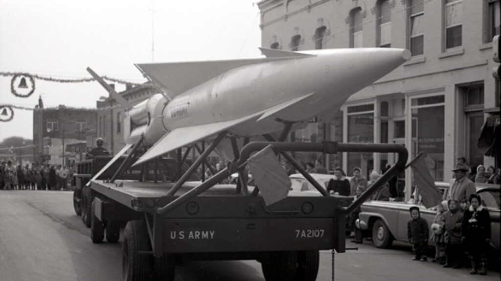 The Hercules Missile is showcased in Naperville's 1959 Santa Parade, traveling down Washington Street on car trailer
