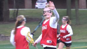 Benet girls lacrosse player waves to the camera before the game against The Valley.