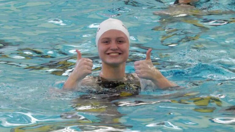 Metea Valley girls water polo player does a thumbs up to the camera.