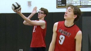 Benet academy boys volleyball players warm up before playing Metea.