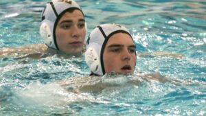 Charlie Drohan scores underwater and celebrates with teammates in picture.