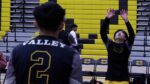 Metea Valley boys volleyball players warm up before a three set thriller against Neuqua Valley.