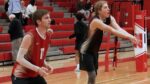 Naperville Central boys volleyball players warm up before playing Naperville North.
