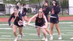 Naperville North girls lacrosse players warm up.