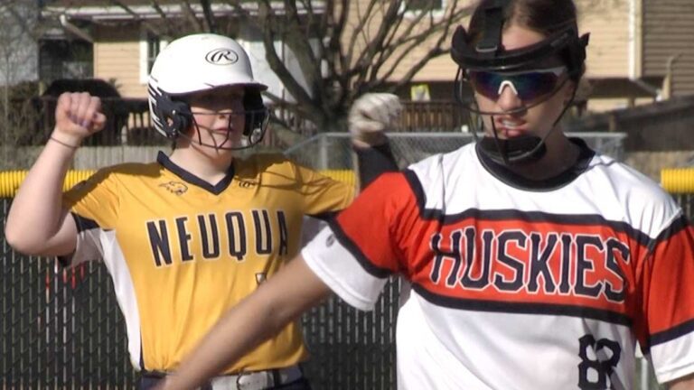 Neuqua Valley softball player celebrates a hit in the DVC opener against Naperville North.