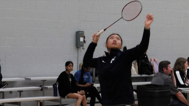 Neuqua badminton player warms up before staying undefeated.