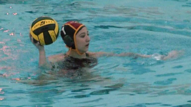 Waubonsie Valley girls water polo goalie warms up.