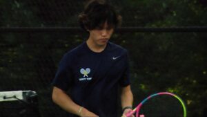 Anthony Yang of Neuqua Valley tennis stands around in between points.