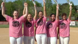 Benet Academy softball seniors wave and smile to the camera.