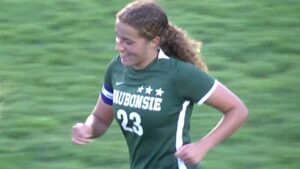 Eleanor Oster runs back after scoring for Waubonsie Soccer.