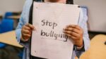 stop bullying sign held up by student