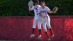 Benet Academy outfielders celebrate a nice catch during a victory over Naperville Central