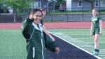 Waubonsie Valley girls soccer player waves to the camera before playing Plainfield East.