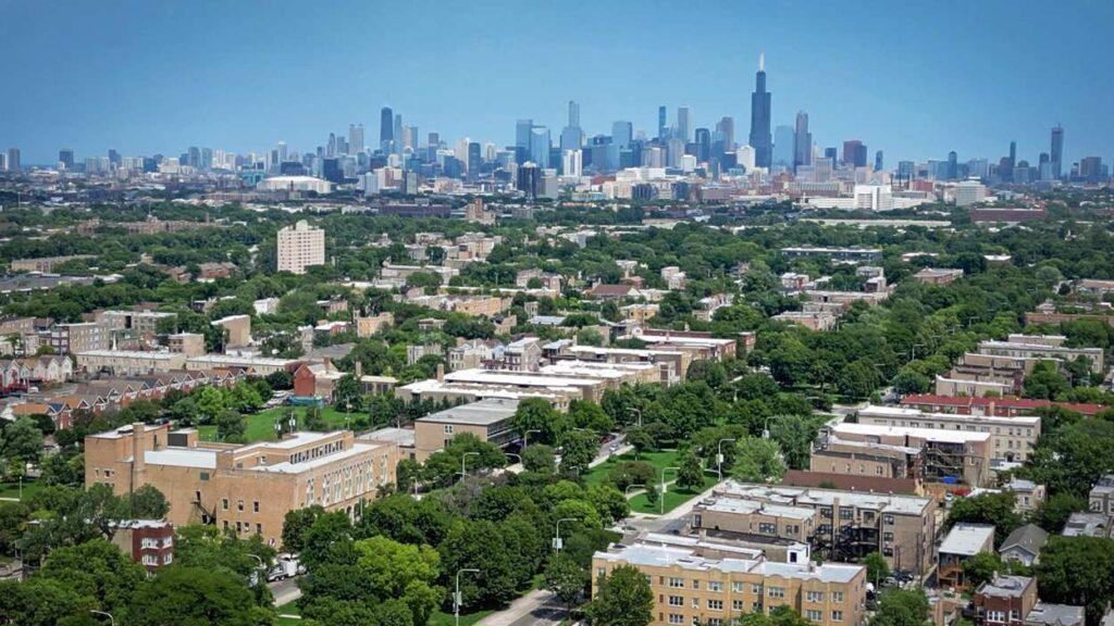 Drone shot of Chicago skyline with trees and urban canopy within houses in surrounding suburbs, courtesy Morton Arboretum