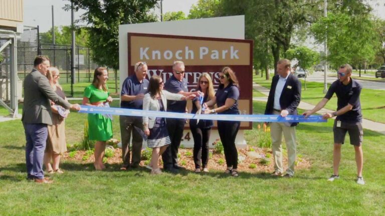 Naperville Park District staff, and representatives from Wintrust/Naperville Bank and Trust, and District 203 cutting the ribbon.