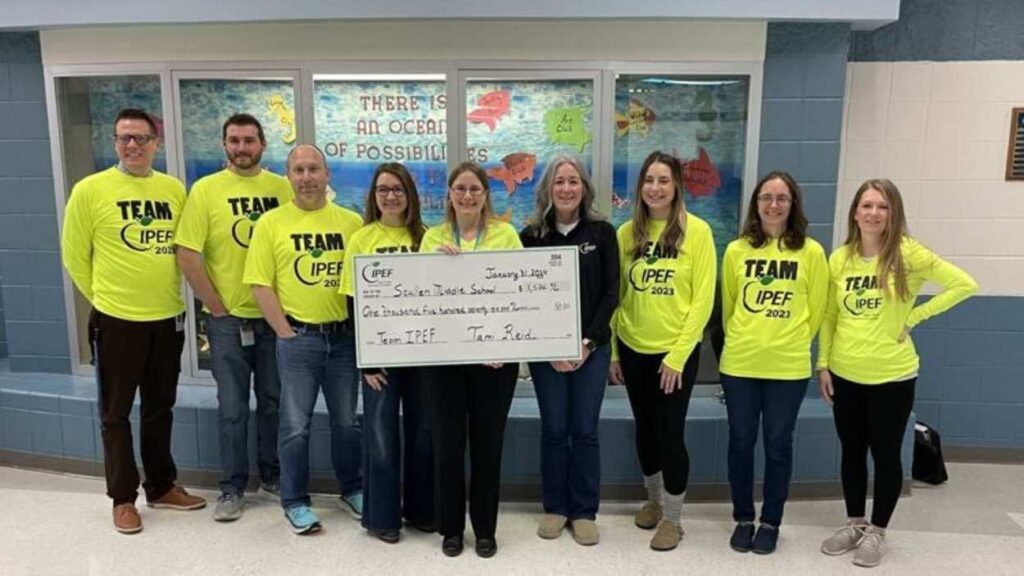 Group of people from IPEF foundation supporting District 204 holding a large check