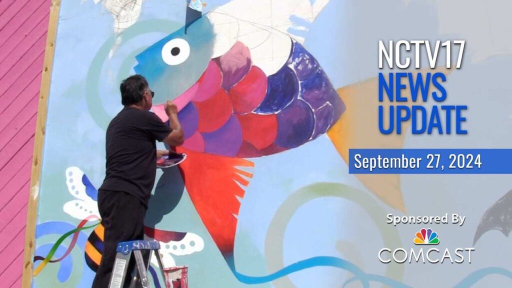 Naperville artist Rich Lo painting the mural outside the DuPage Children's Museum with the NCTV17 News Update logo.