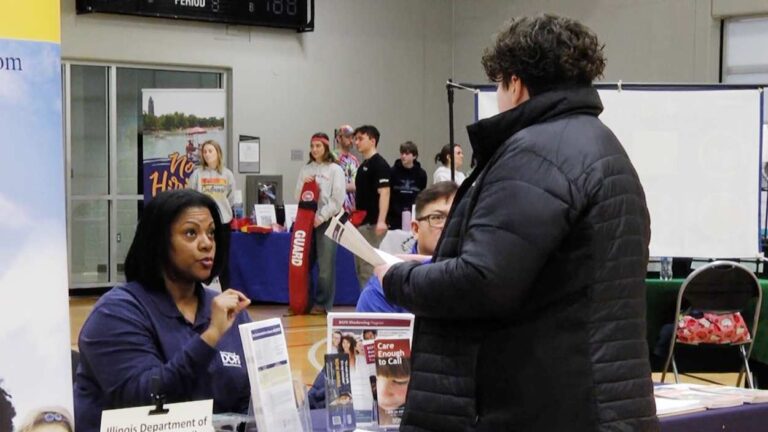 Business representative speaking with job seeker at the Community Job Fair